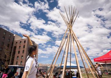 Auraria NISA Circle member helping set up tipi.